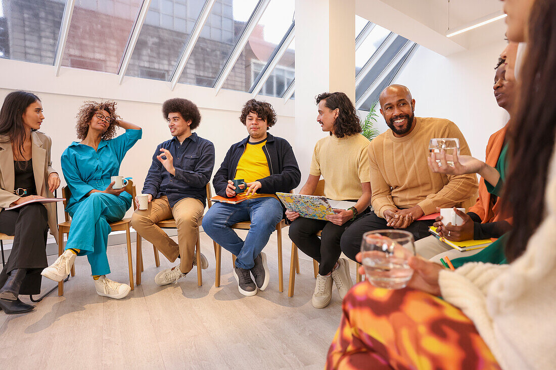 Employees in discussion at team meeting