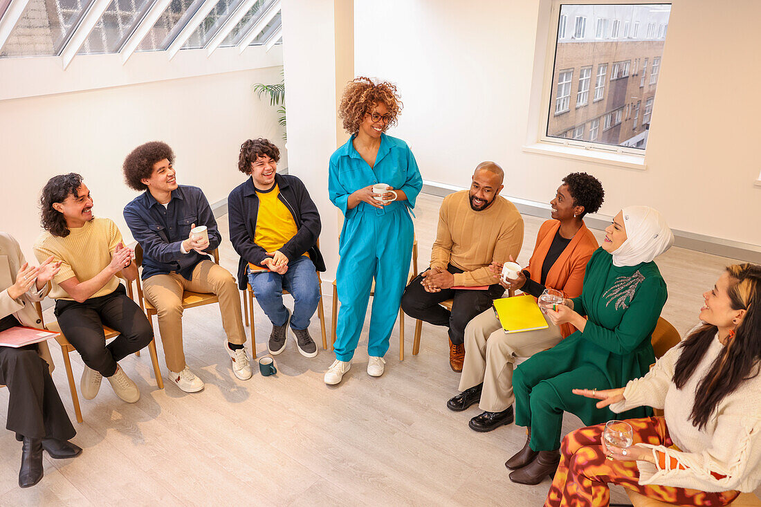 Employee leading discussion in team meeting