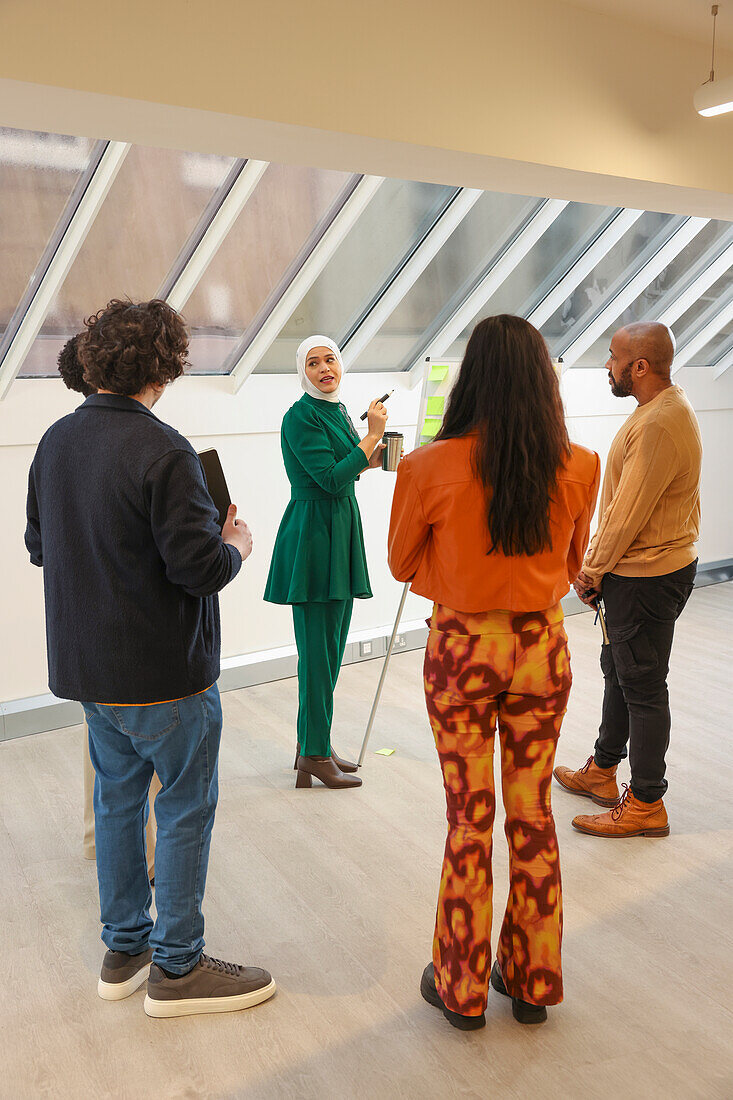 Employees having team meeting in office