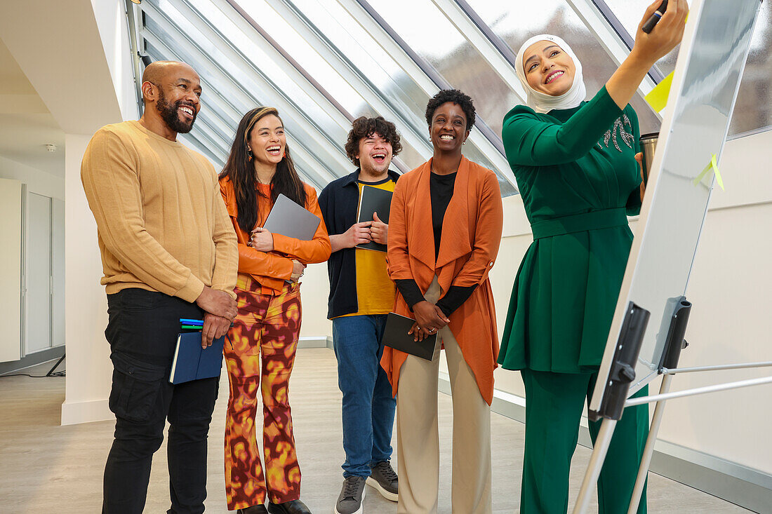 Employees smiling during team meeting in office