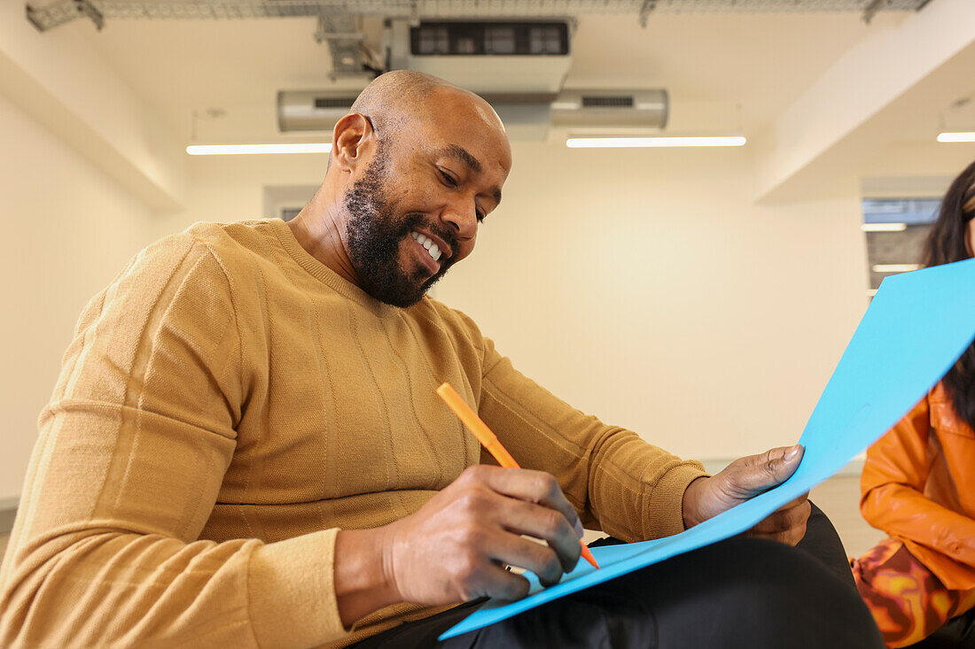 Company employee writing in office