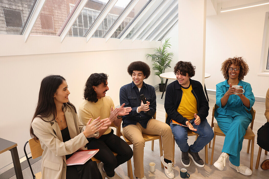 Creative workers clapping in office