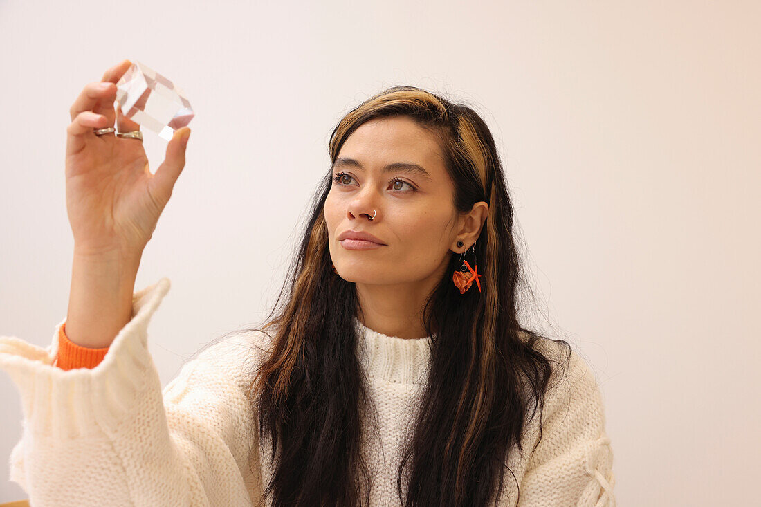 Woman holding glass cube