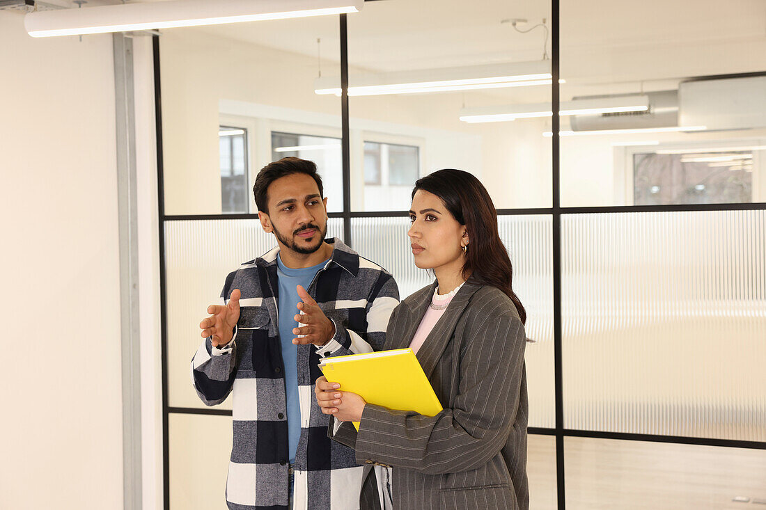 Coworkers talking in office