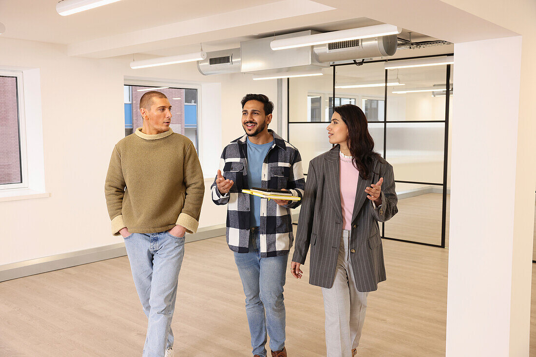 Coworkers talking in empty office