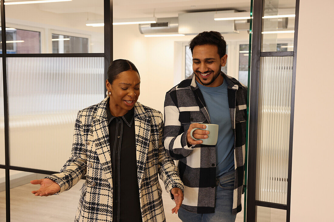 Coworkers walking in office