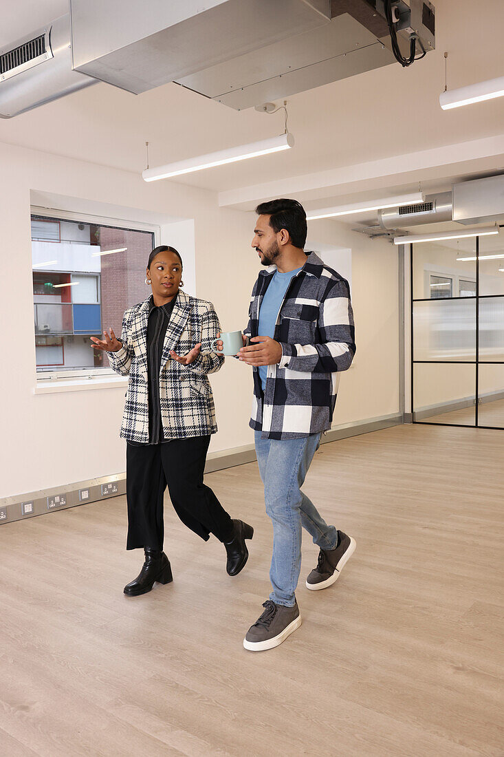 Coworkers walking in office