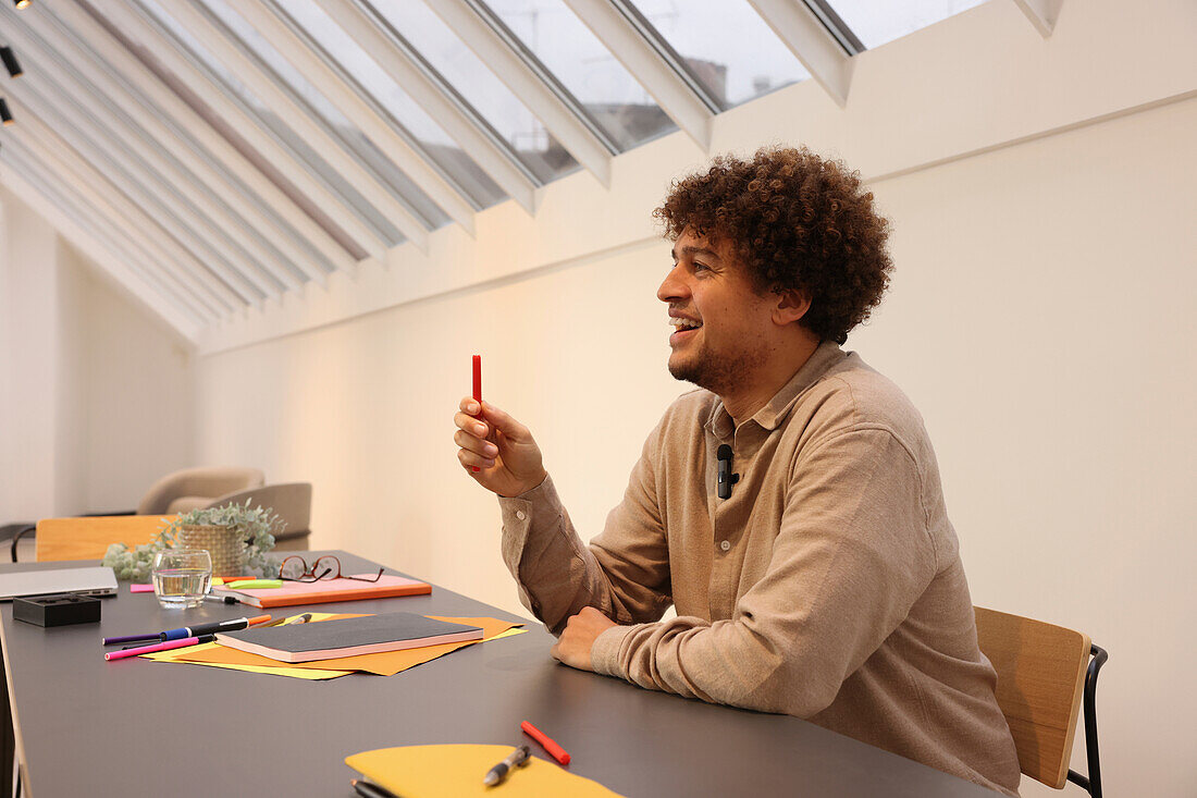 Smiling man sitting at table in office