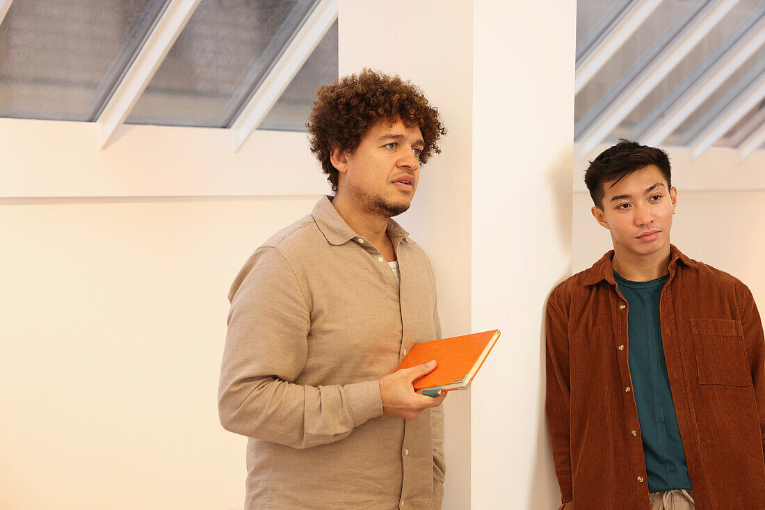 Coworkers standing in office