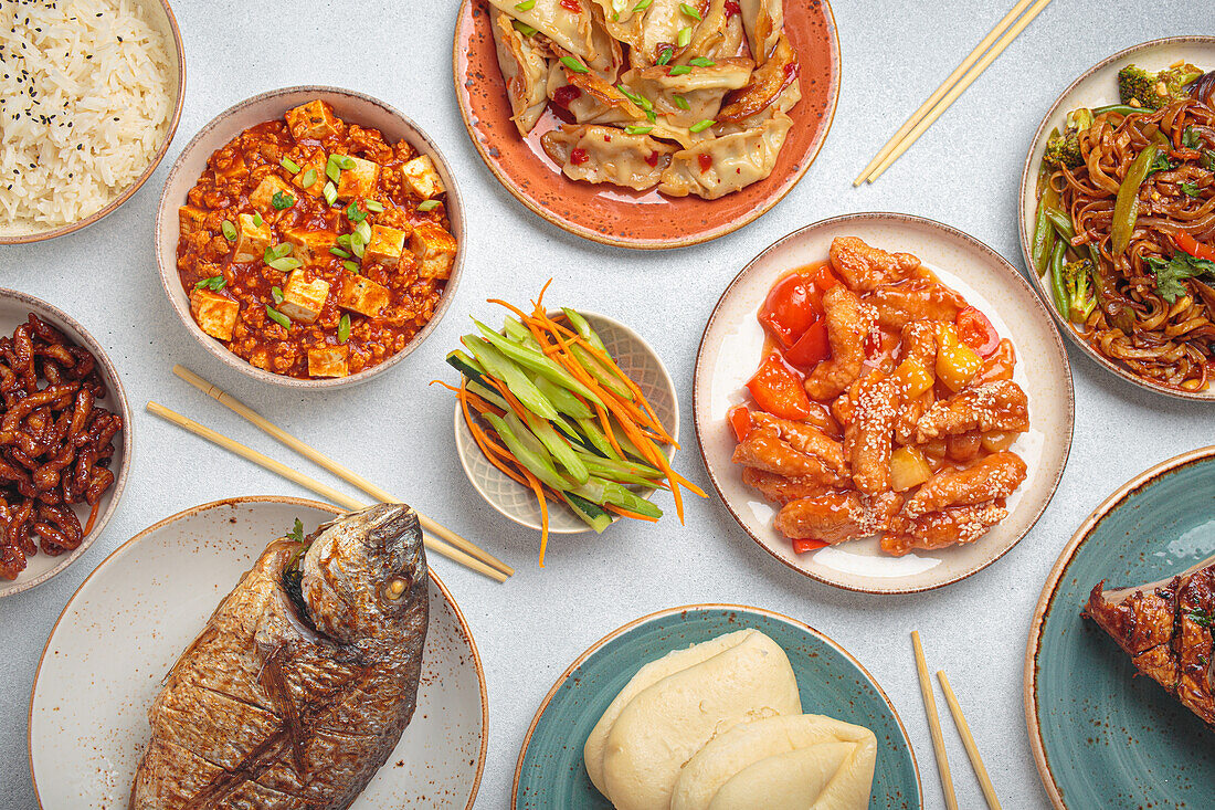 Chinese festive table with dumplings, mapo tofu and kung pao chicken