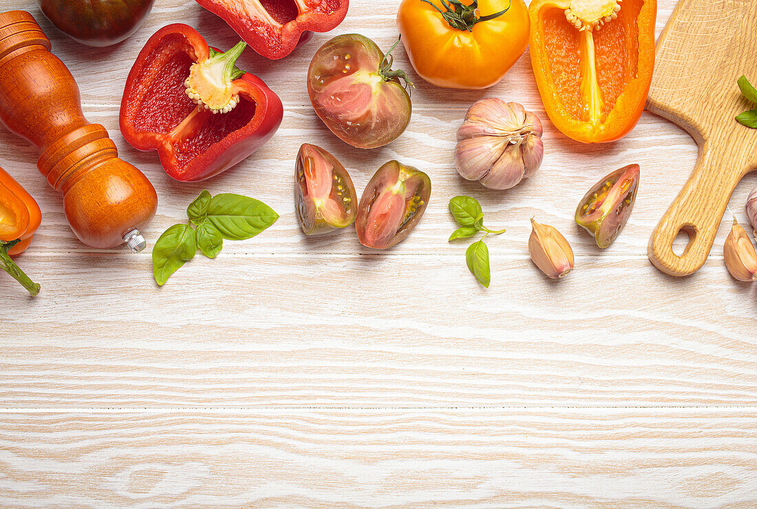 Yellow and red tomatoes and peppers on a wooden table