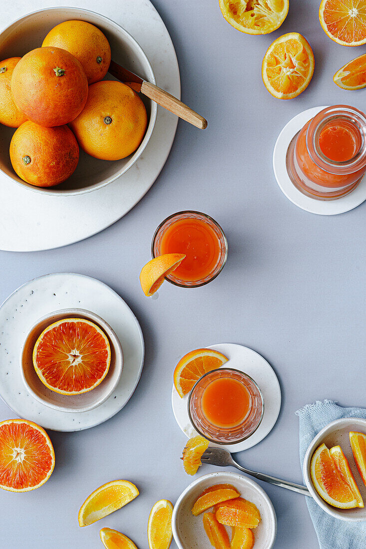 Freshly squeezed blood orange juice with orange wedges