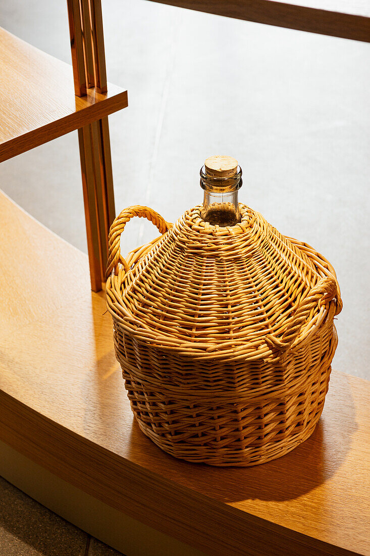 Cognac bottle in wicker basket