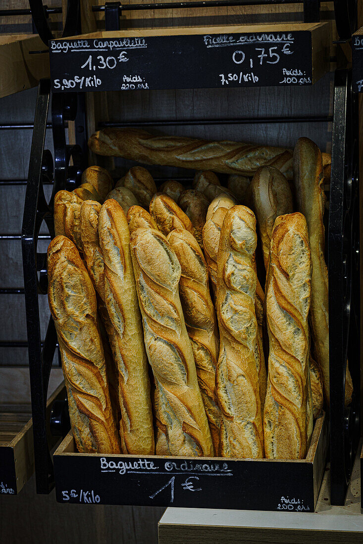 Baguettes in a French bakery with price boards