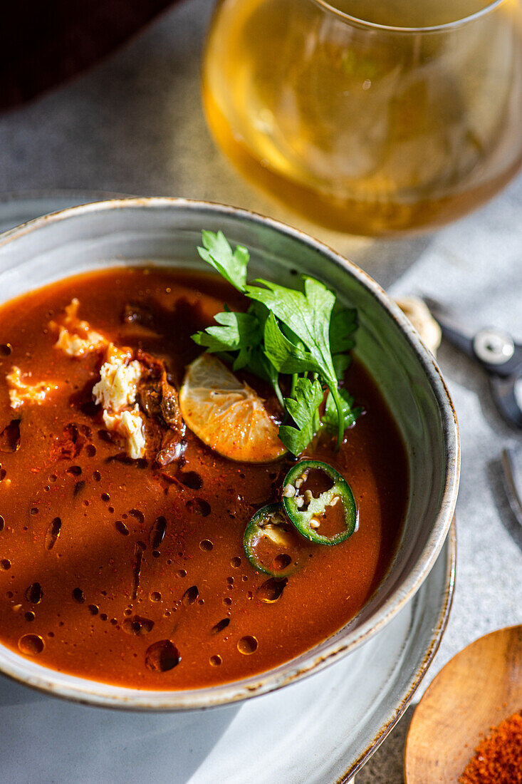 Spicy cream of tomato soup with cream cheese and parsley