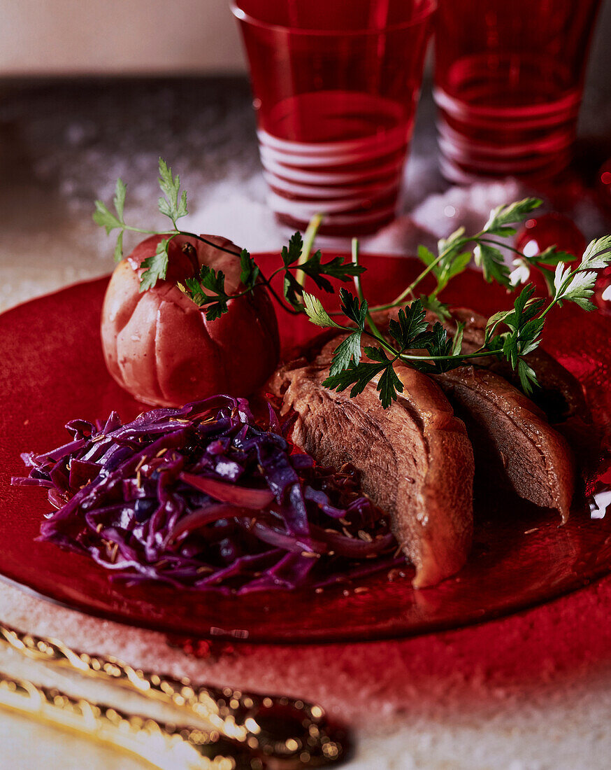 Roast goose with red cabbage and baked apple