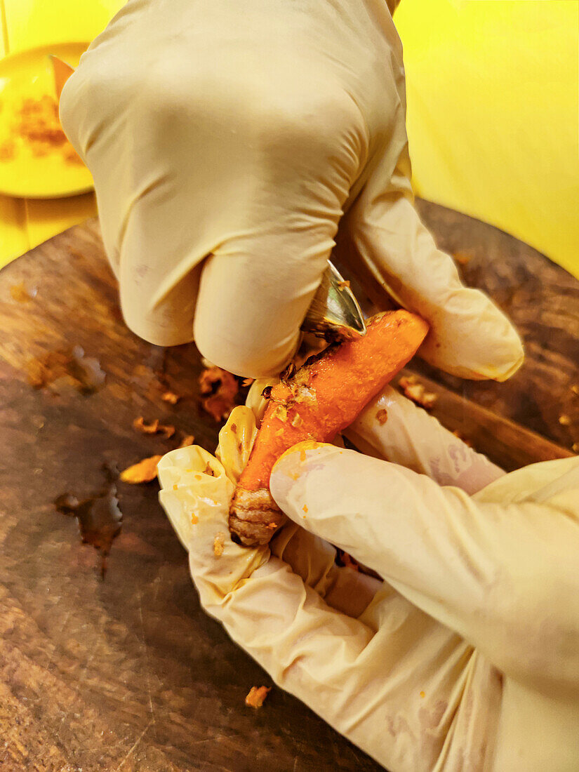 Fresh turmeric root is peeled