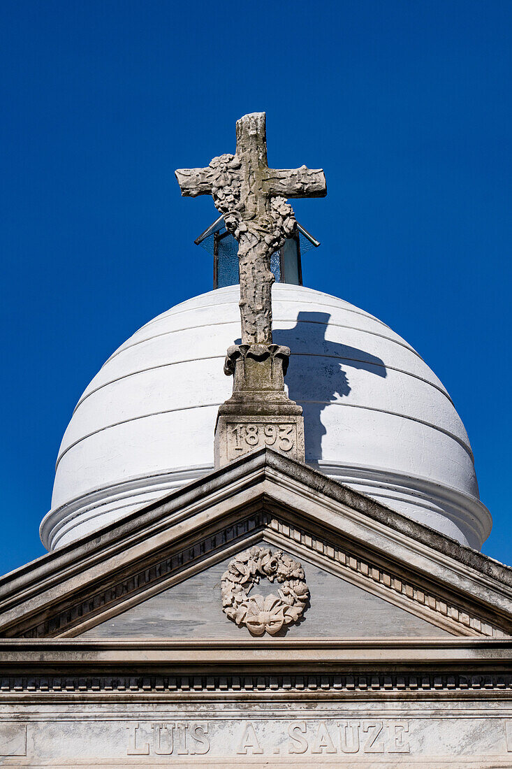 A cross on an elaborate tomb or mausoleum in the Recoleta Cemetery, Buenos Aires, Argentina.