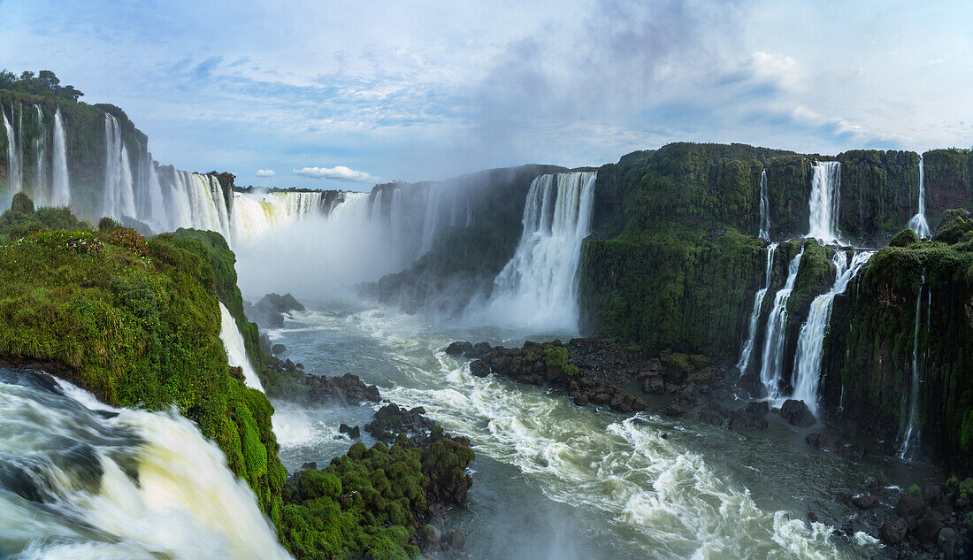 Iguazu Falls National Park in Argentina at right with Brazil at left. A UNESCO World Heritage Site. Pictured is the top Santa Maria Waterfall in front with the Devil's Throat or Garganta del Diablo, center, and the Two Musketeers and Three Musketeers Waterfalls at right.