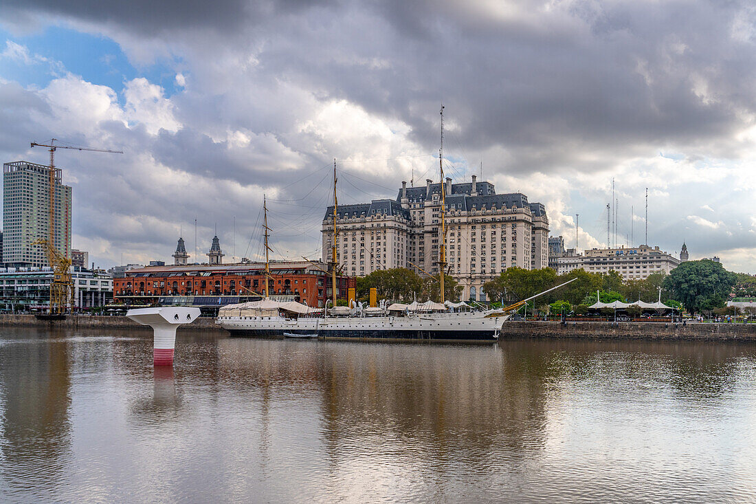 La Puente de la Mujer or the Woman's Bridge over Dock 3 in Puerto Madero, Buenos Aires, Argentina. Behind is the ARA Presidente Sarmiento ship and the Libertador Building, headquarters of the Ministry of Defense.