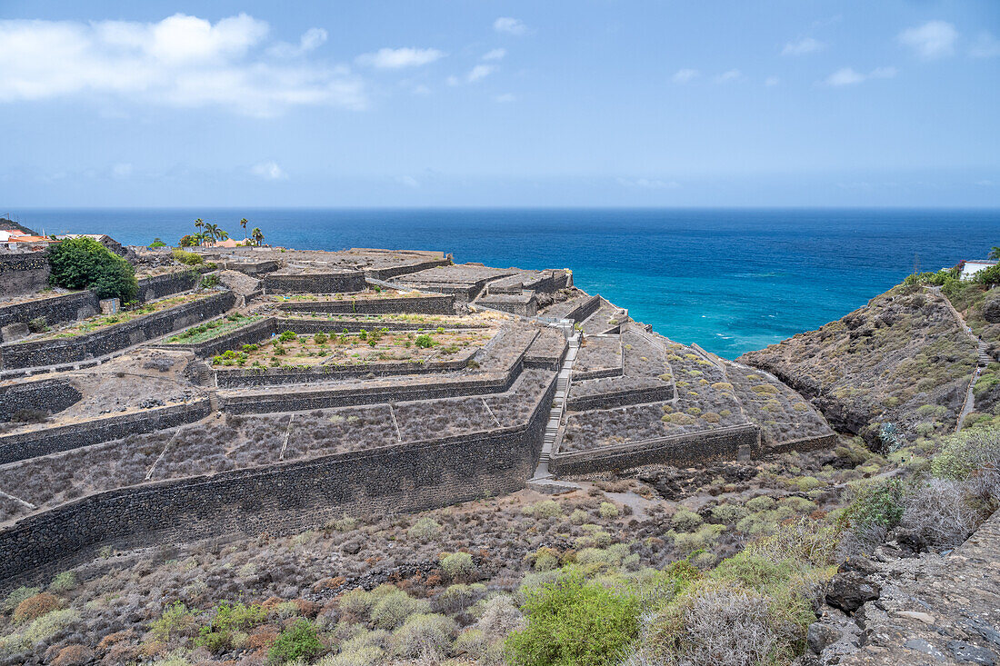 Terraced agricultural fields on volcanic terrain near Bollullo, Tenerife. Overlooking the Atlantic Ocean in the Canary Islands, Spain.