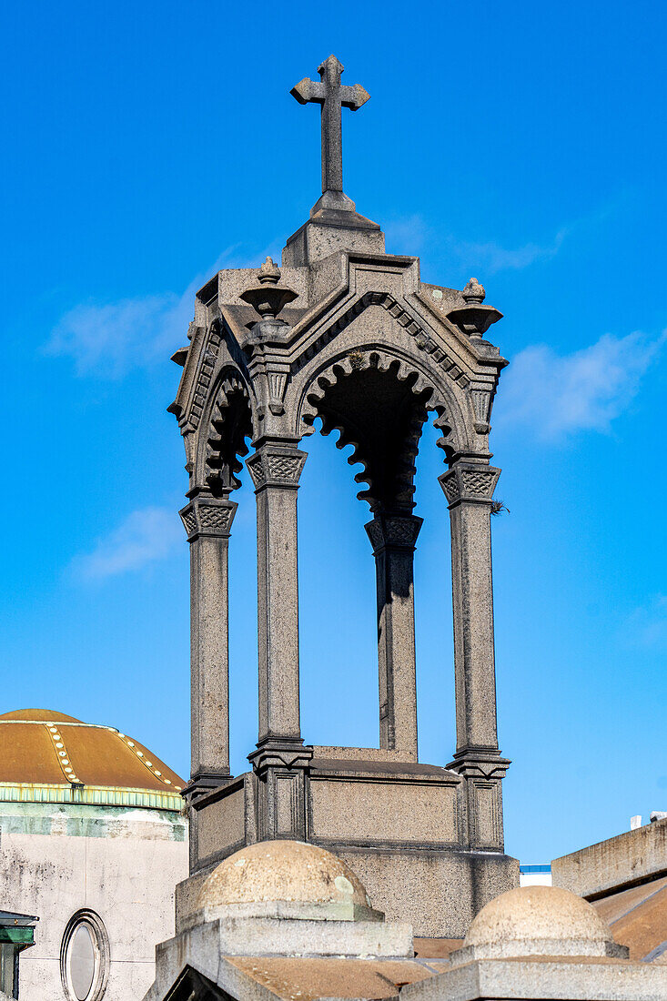 A cross on an elaborate tomb or mausoleum in the Recoleta Cemetery, Buenos Aires, Argentina.