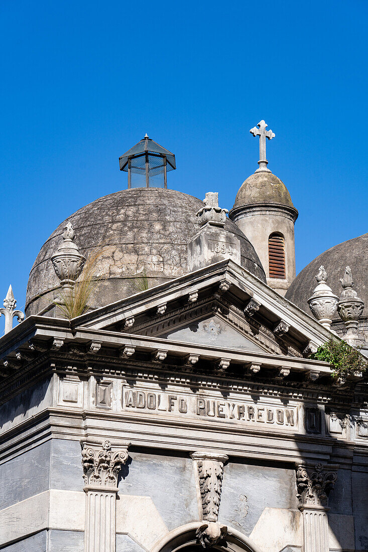 A cross on an elaborate tomb or mausoleum in the Recoleta Cemetery, Buenos Aires, Argentina.