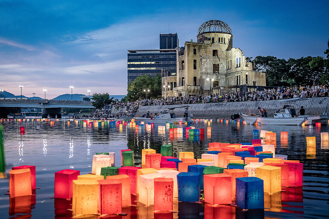 People float lanterns on the river, in front of Atomic Bomb Dome with floating lamps on Motoyasu-gawa River during Peace Memorial Ceremony every August 6 in Hiroshima, Japan