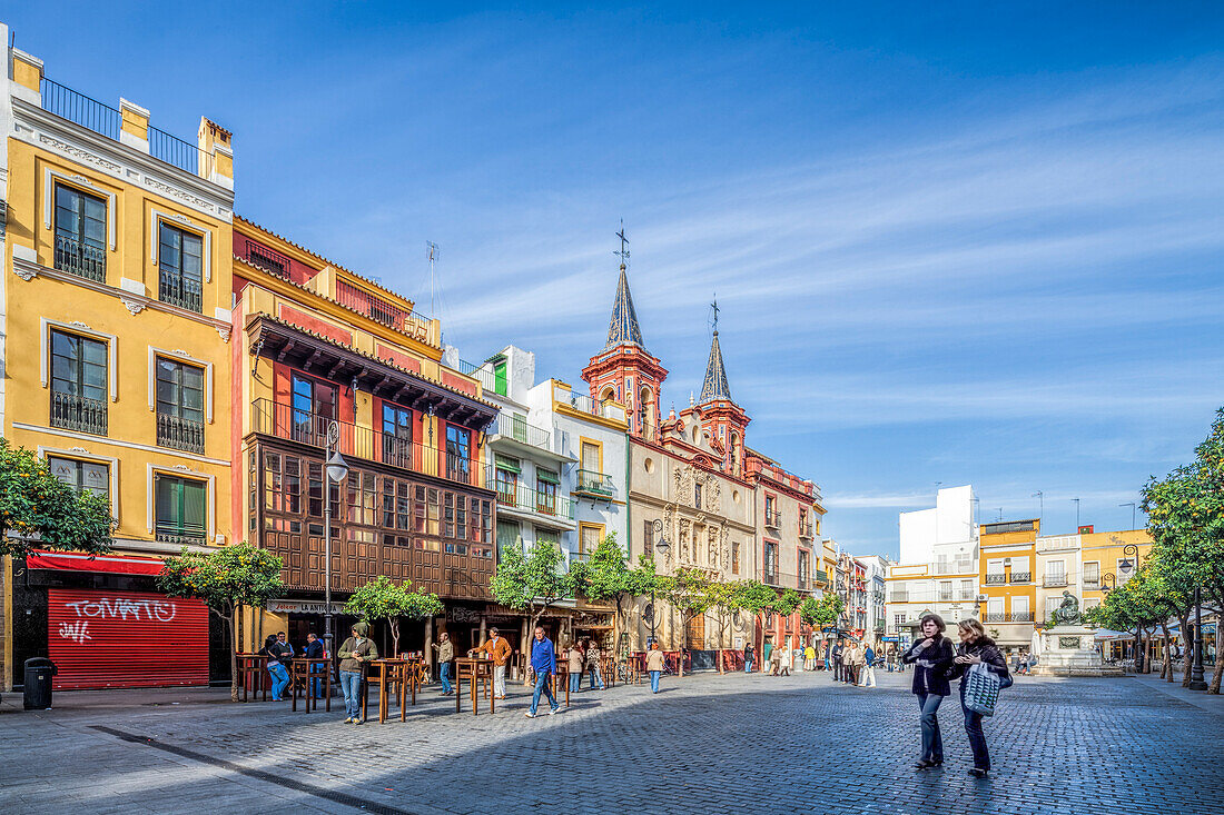 Seville, Spain, Nov 15 2009, Visitors bask in a sunny El Salvador square, surrounded by vibrant buildings and the iconic belfries of the old San Juan de Dios hospital.