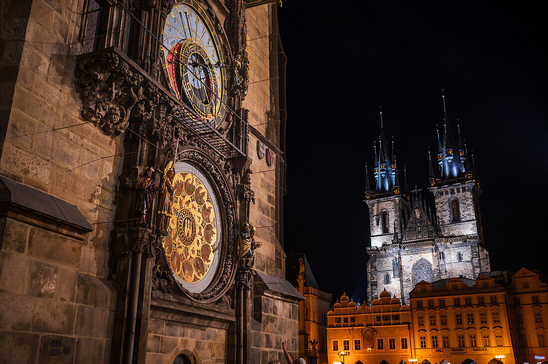 Astronomical Clock in Old Town Hall tower and Church of Our Lady before Tyn at night, Prague