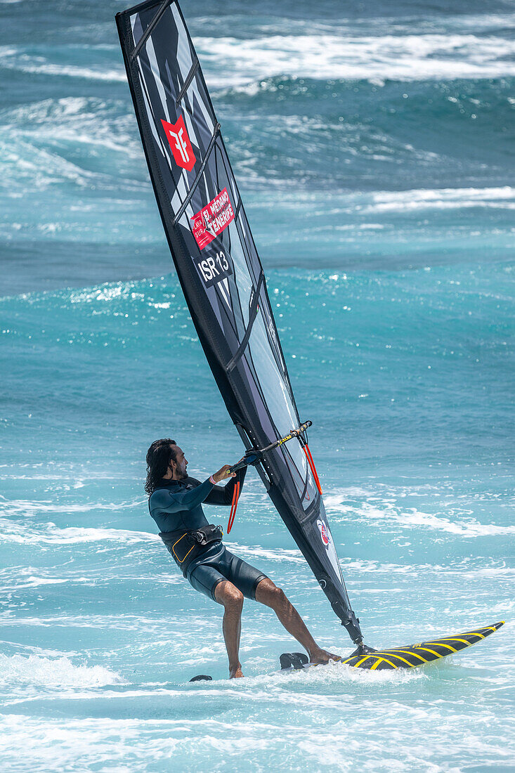 Exciting windsurfing action at the World Championship in El Medano, Tenerife, Spain. Captured in August 2024, showcasing skill and thrill in vibrant waves.