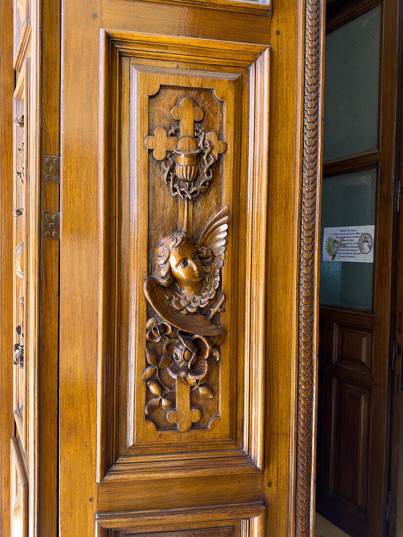 The face of an angel carved in the wooden door of the Cathedral of San Salvador de Jujuy, Argentina.