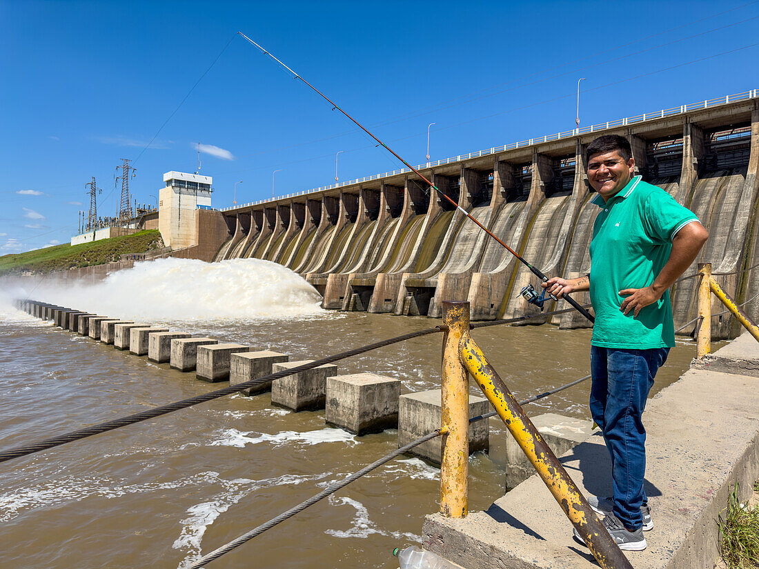 A man fishing in the tailwater below the spillway of the Rio Hondo Dam at Termas de Rio Hondo, Argentina.