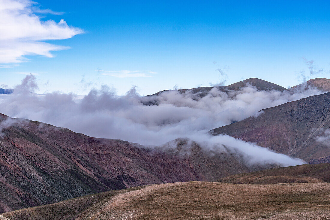 Low clouds in the mountains of the Cuesta de Lipan between Purmamarca and Salinas Grande, Argentina.