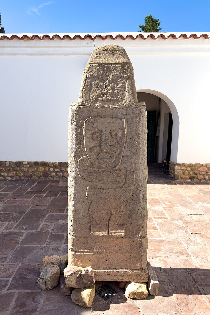 A carved bas relief monolith in the courtyard of the Dr. Eduardo Casanova Archeology Museum in Tilcara, Argentina.