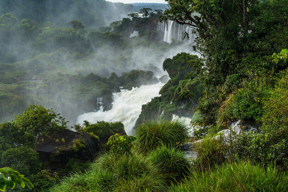 Iguazu Falls National Park in Argentina. A UNESCO World Heritage Site. Pictured is San Martin in the center through the tropical rainforest, with a stone arch or window by the Hidden Falls or Salto Escondido.