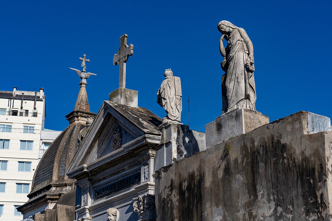 A statue of a woman on a mausoleum in the Recoleta Cemetery in Buenos Aires, Argentina.