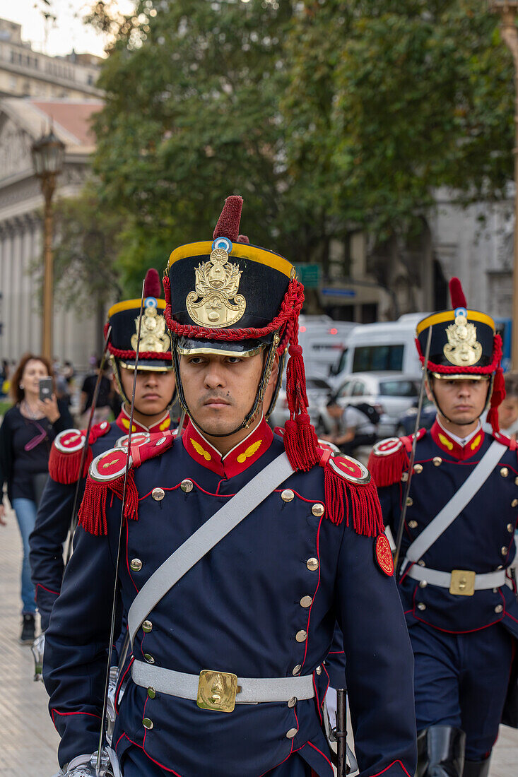 The military honor guard marching from the tomb of San Martin in the Cathedral to the Casa Rosada in Buenos Aires, Argentina. The soldiers are members of the Ayacucho Squadron of the Regiment of Horse Grenadiers.