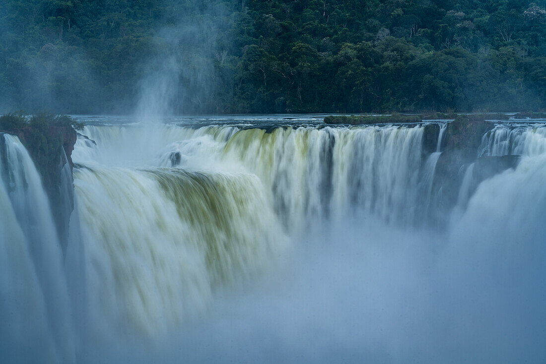 Iguazu Falls National Park in Argentina at right with Brazil at left. A UNESCO World Heritage Site. Pictured is the Devil's Throat or Garganta del Diablo, the largest of the falls at Iguazu and the border between the two countries runs through this waterfall.