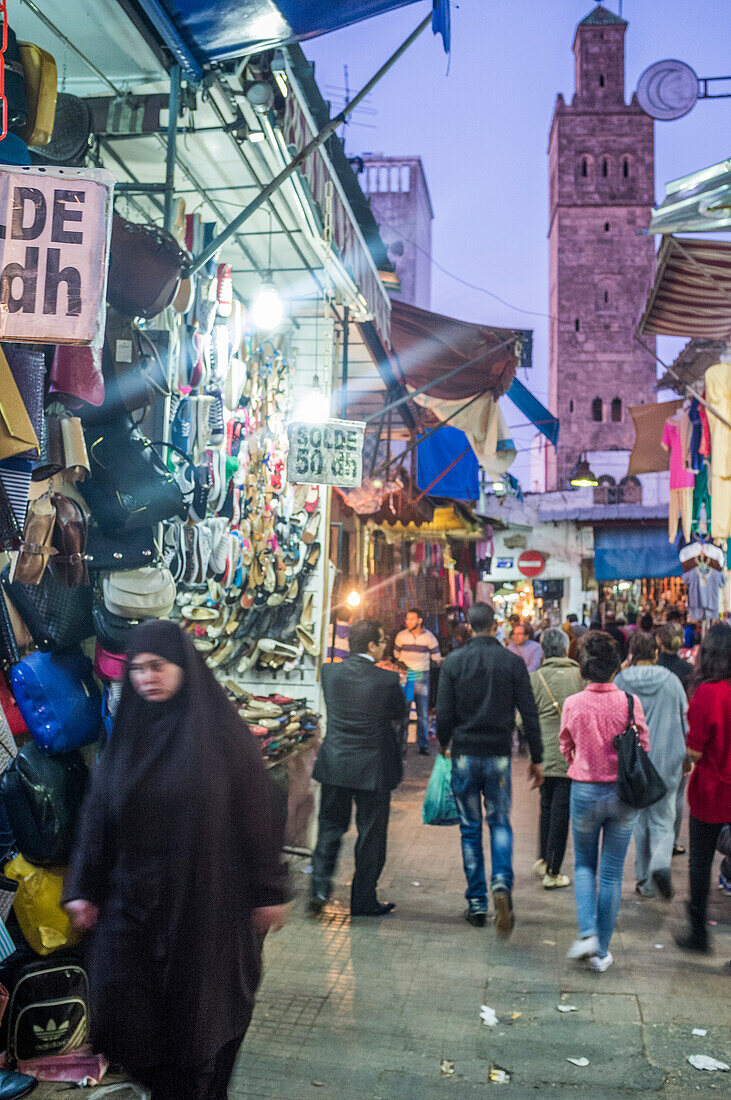 Rabat, Morocco, Apr 24 2015, Visitors explore vibrant shops in Rabat\'s Medina, surrounded by colorful textiles and local crafts as the sun sets.