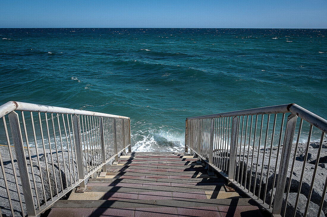 Stairs leading to a beach that has disappeared, in Vilassar de Mar, El Maresme, Catalonia, Spain