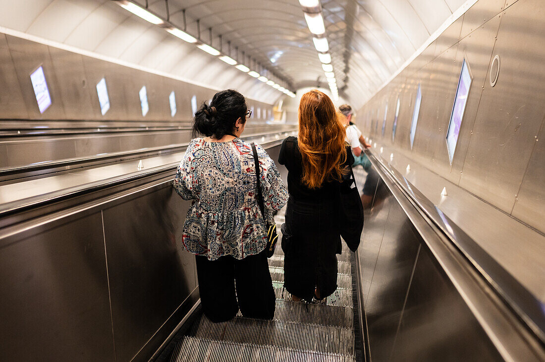 People using Prague Metro electric stairs