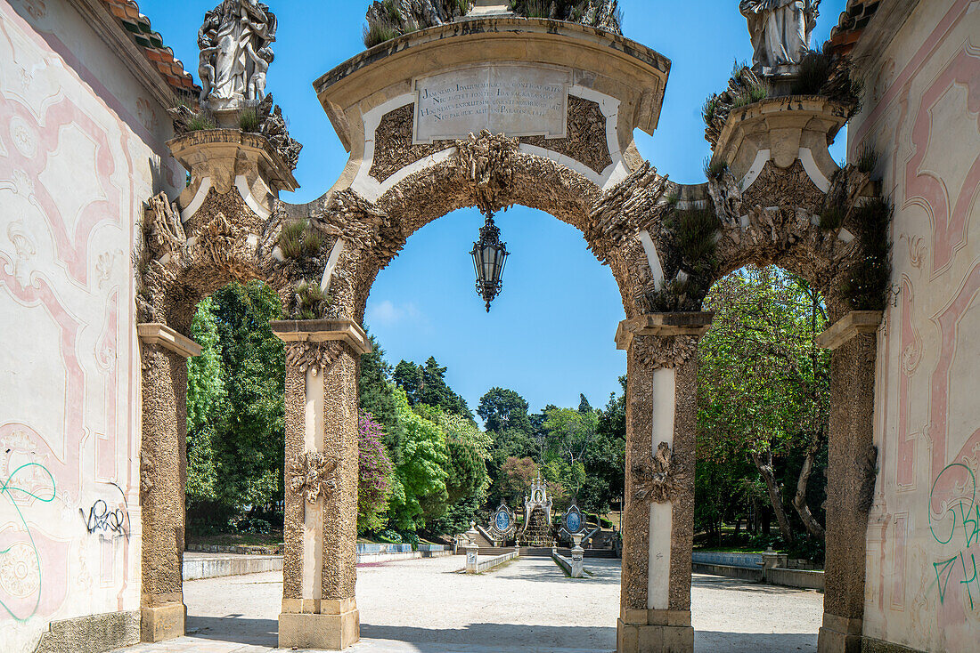 Beautiful archway at Parque de Santa Cruz in Coimbra, Portugal, surrounded by nature.