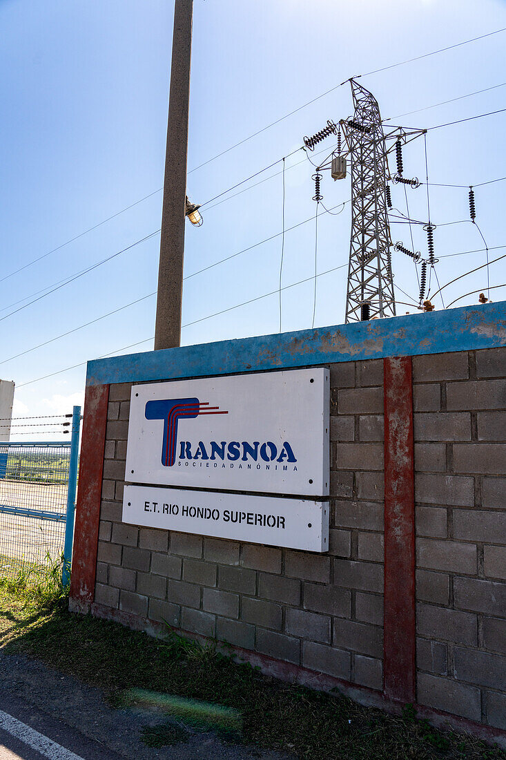 Sign for the Transnoa hydroelectric power generating station on the Rio Hondo Dam at Termas de Rio Hondo, Argentina.