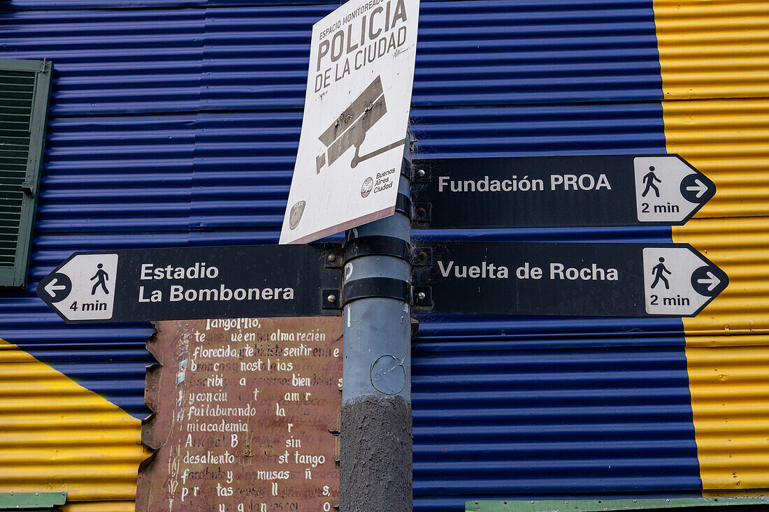 Street sign with a colorfully-painted building on Dr. del Valle Iberlucea Street in Caminito, La Boca, Buenos Aires, Argentina.