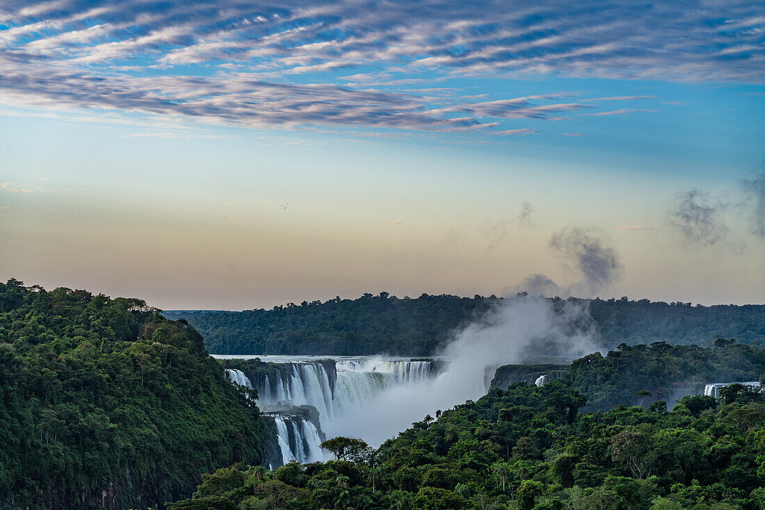 The Devil's Throat or Garganta del Diablo at sunrise at Iguazu Falls National Park in Argentina. A UNESCO World Heritage Site. Brazil is on the left side of the canyon, with Argentina on the right.