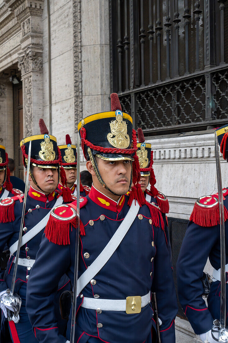 The military honor guard marching from the tomb of San Martin in the Cathedral to the Casa Rosada in Buenos Aires, Argentina. The soldiers are members of the Ayacucho Squadron of the Regiment of Horse Grenadiers.