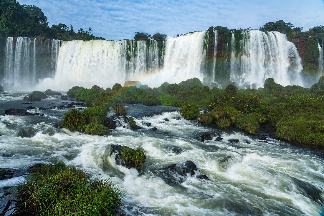 A rainbow in front of the Floriano Waterfall at Iguazu Falls National Park in Brazil. The top of the Santa Maria Falls is in front. A UNESCO World Heritage Site.