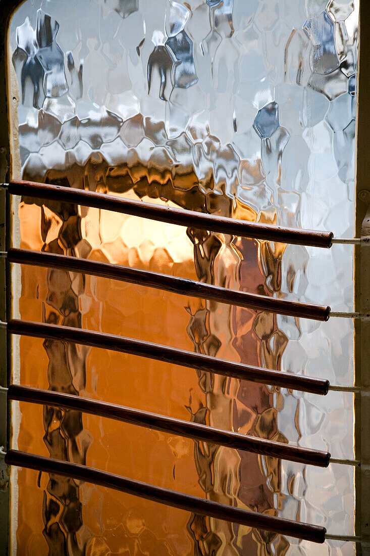 Barcelona, Spain, Sept 4 2008, Through the frosted glass, warm light illuminates the intricate designs of Casa Batlló, showcasing Gaudís signature style in Barcelona.