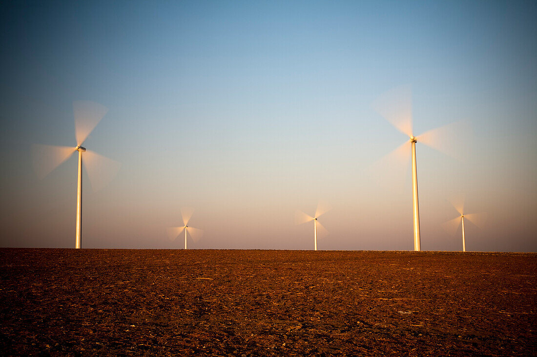 Windmills stand tall under the dusky sky of Sanlucar de Barrameda, generating clean energy for the town.